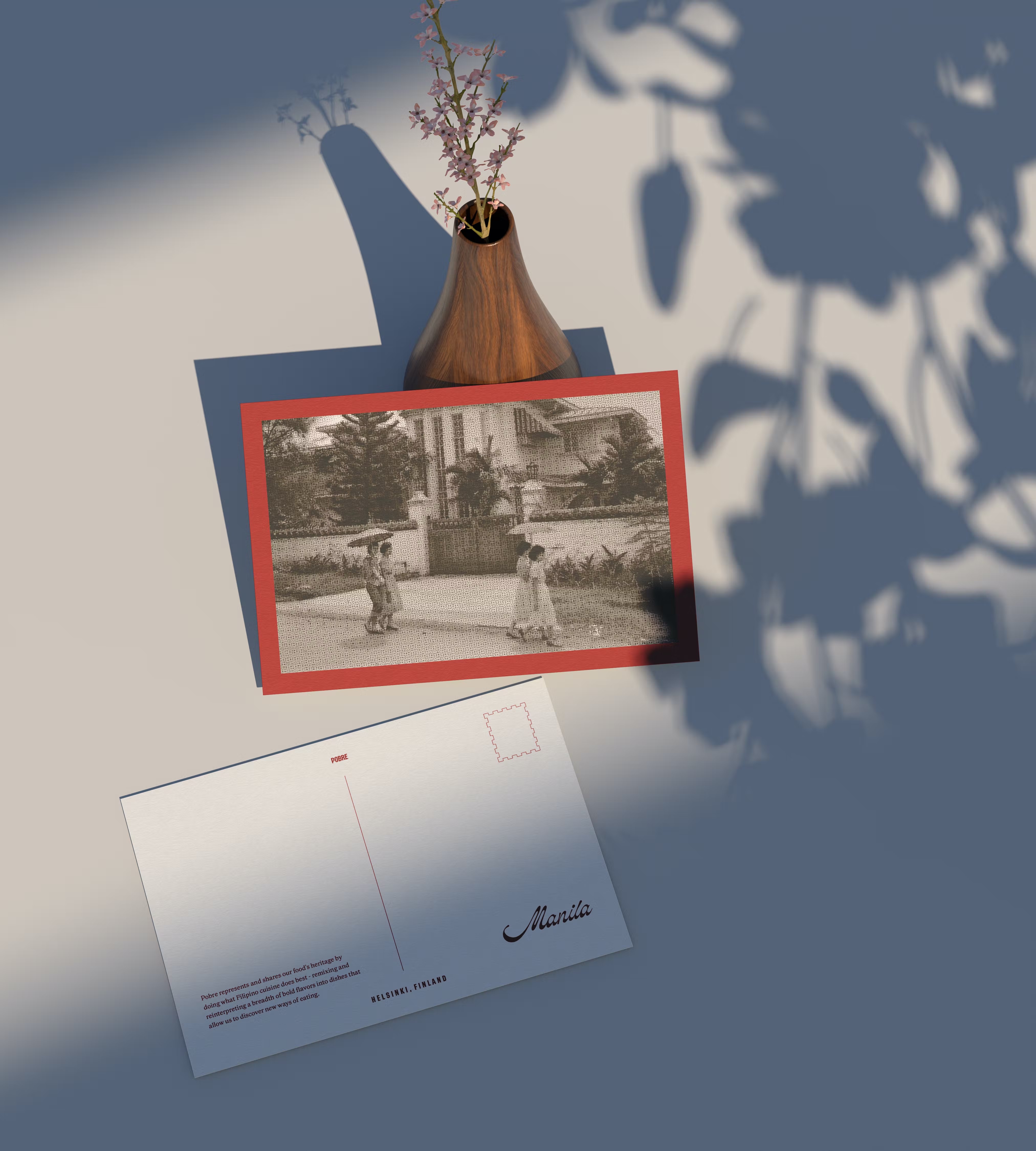 A POBRE gift card postcard propped against a vase, Manila script on the reverse.